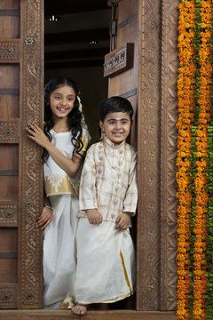 South Indian girl standing with her brother 