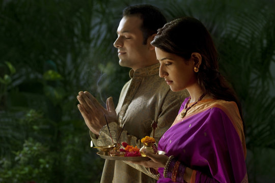 Couple praying during diwali 