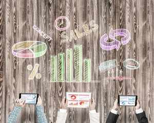 Top view of businesspeople sitting at table and using gadgets