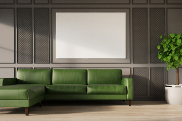 Gray wall, green sofa, poster