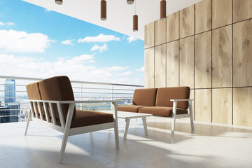 Wooden balcony, brown armchairs, cityscape