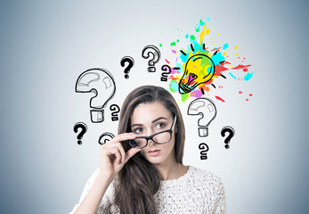 Young woman taking off glasses, idea and questions