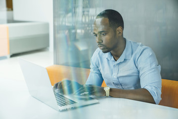 Business man working on laptop computer in modern office space