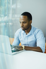 Business man working on laptop computer in modern office space