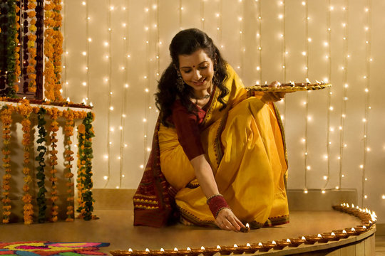 Woman arranging diyas 