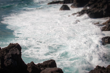 Tilt shift effect of wave lather on rocks, Los Hervideros,Lanzarote, Canary Islands