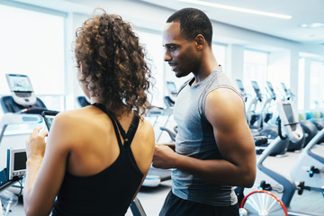 Man and woman looking at a cell phone in the gym 