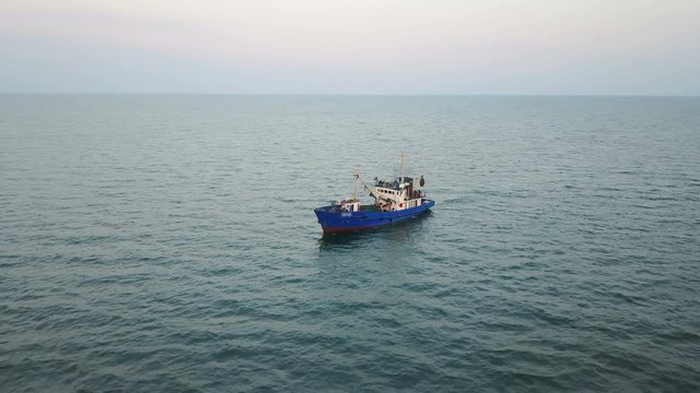 Fishing boat in the Azov Sea at sunset. aerial survey