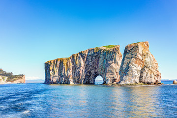 Naklejka premium Rocher Perce rock in Gaspe Peninsula, Quebec, Gaspesie region with birds and cliffs during day