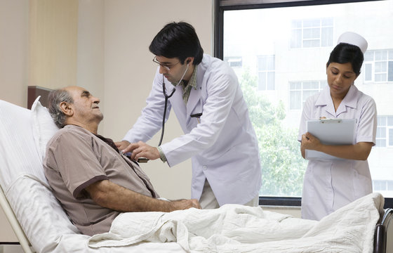 Doctor checking a patient's heartbeat 