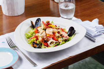 Salad sea cocktail with octopus, mussels, squid rings and shrimps
