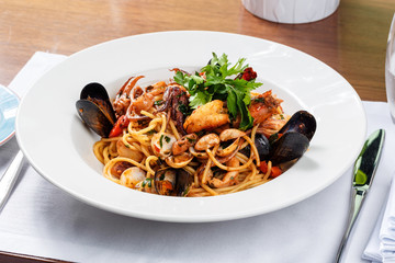 spaghetti sea food on white plate.