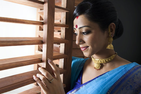 Bengali woman peeking out of a window Stock Photo | Adobe Stock