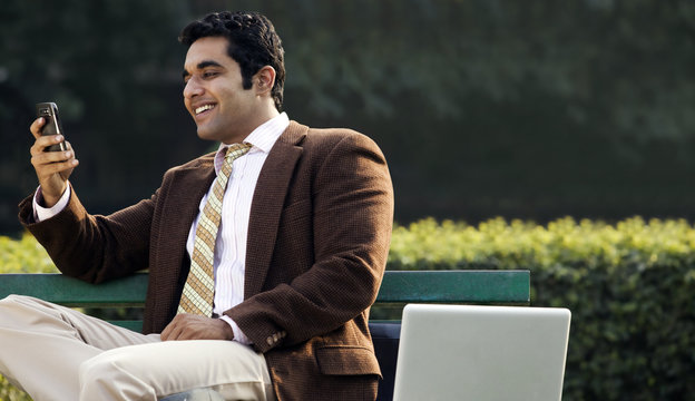 Businessman reading a message on a mobile phone 