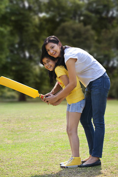 Mother and daughter playing cricket 