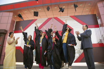 Graduate students throwing their hats in the air