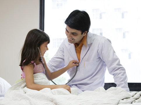 Girl checking a doctors heartbeat 