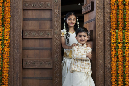South Indian girl standing with her brother 