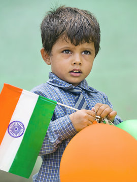 School boy holding the Indian flag 