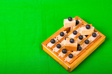 Wooden Brain Teaser or Wooden Puzzles on green background