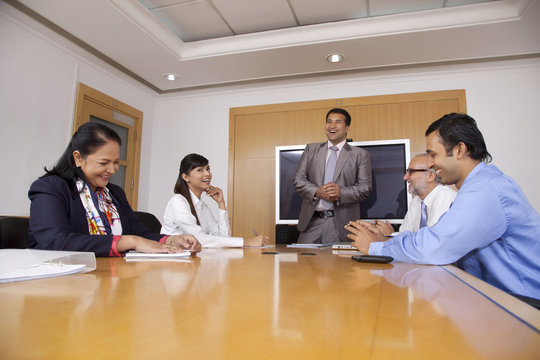 Business executives having a laugh during a meeting