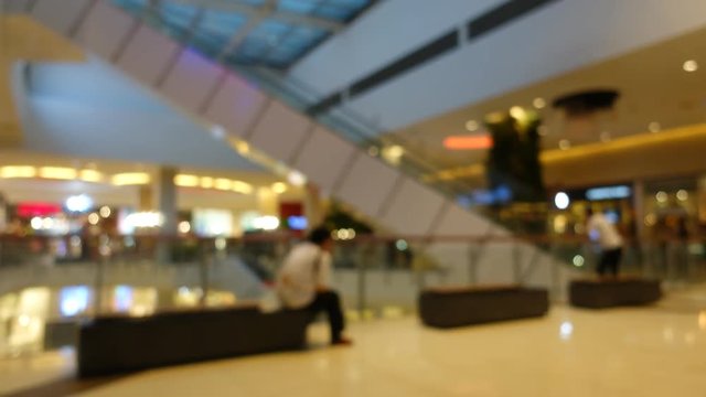 Time lapse, people walking in shopping mall, abstract blur background