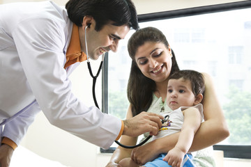 Doctor checking the heartbeat of a baby 
