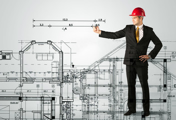 An young architect drawing a house plan