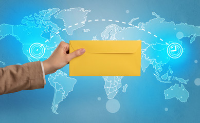 Hand holding envelope with global concept