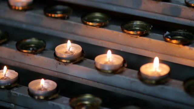 Candles burn near the altar, church ritual