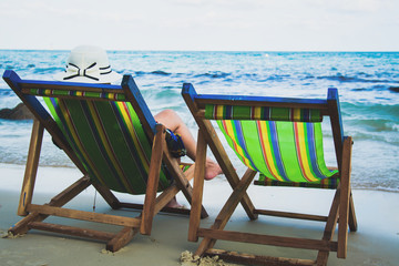 Woman on a tropical beach in chaise lounge at Thailand