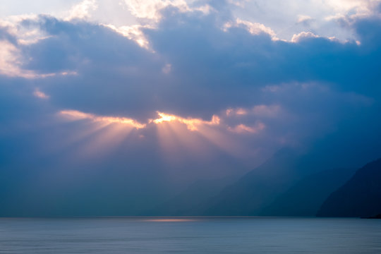 Sun-beams at sunset over Lake Atitlan viewed from the shores of the lake in the small village of Panajachel in Guatemala.