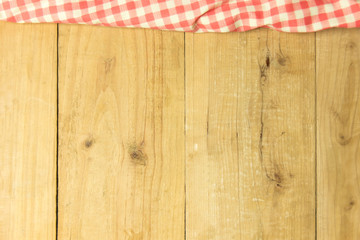 Brown plaid on wooden table textured background, copy space