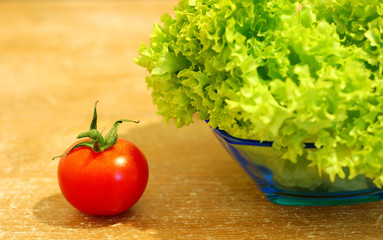 Fresh salad and a  tomato