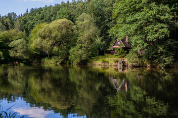 Fototapeta na wymiar Cottage by the river