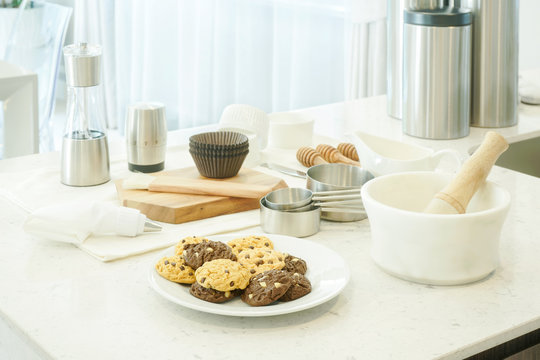Bakery tools, ingredients and cookies on counter top in kitchen