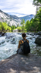 Girl sitting in front of lake