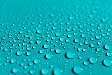 Water drops on a blue surface, background