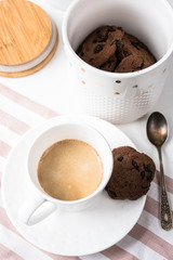 Cup of coffee and jar of chocolate cookies