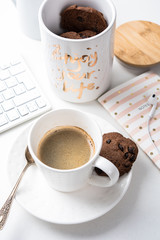 Cup of coffee and jar of chocolate cookies