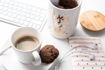 Cup of coffee and jar of chocolate cookies