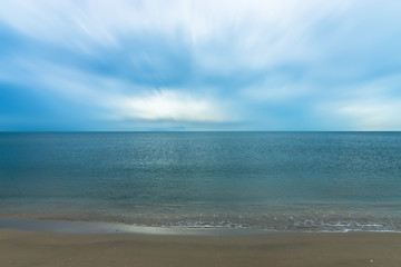 Fototapeta na wymiar Quiet blue sea with motion cloud.