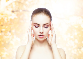 Portrait of young, natural and healthy woman over yellow autumn background. Healthcare, spa, makeup and face lifting concept.