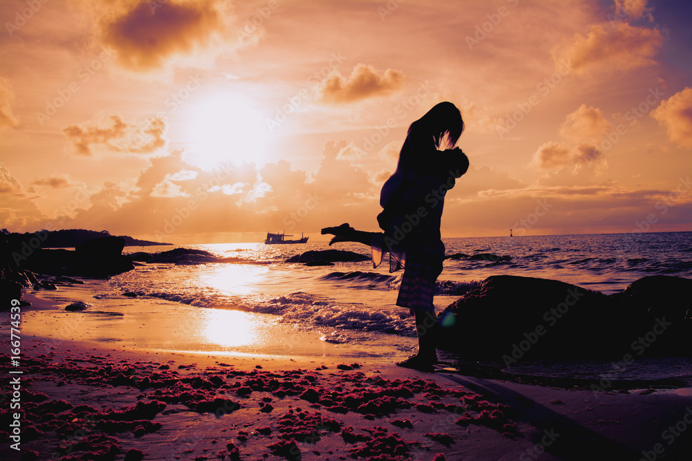 Wall mural Sweet girlfriend on the beach at evening.