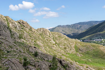 View of the village of Asubulak, Kazakhstan. Beautiful clouds over the village surrounded by mountains