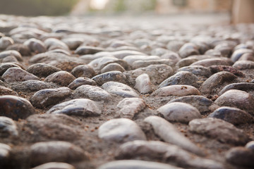 Close up view on the road pavement bricks. Old cobblestone walkway
