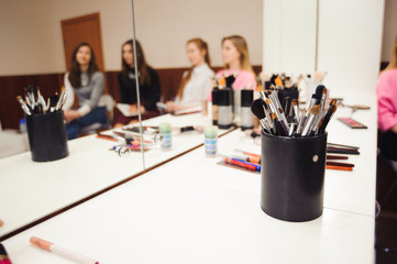 School of makeup. Students of a professional make-up artist in class