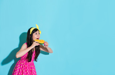 girl looking at empty area eating watermelon