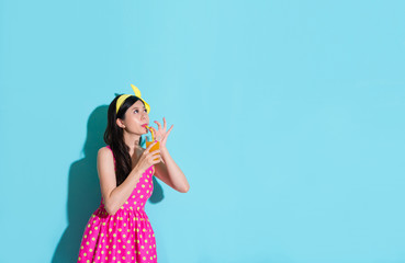 elegant beauty girl drinking orange beverage