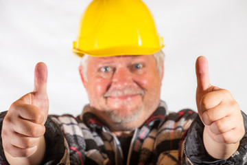 A craftsman smiles and pointing with the thumb up